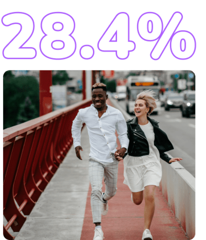 A black and white interracial couple running enthusiastically along a bridge walkway